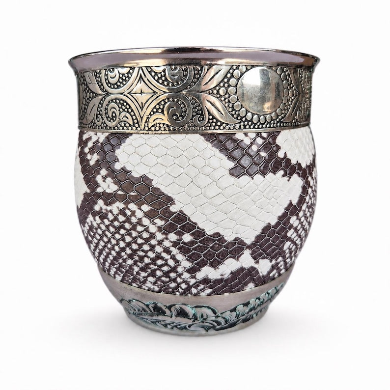 Close up of embossed silver rim on mate cup