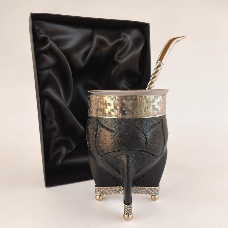 Black mate cup with textured surface and silver legs
