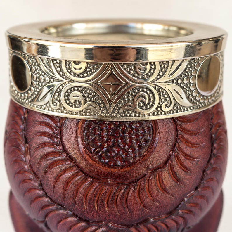 Brown leather mate with carved swirling pattern